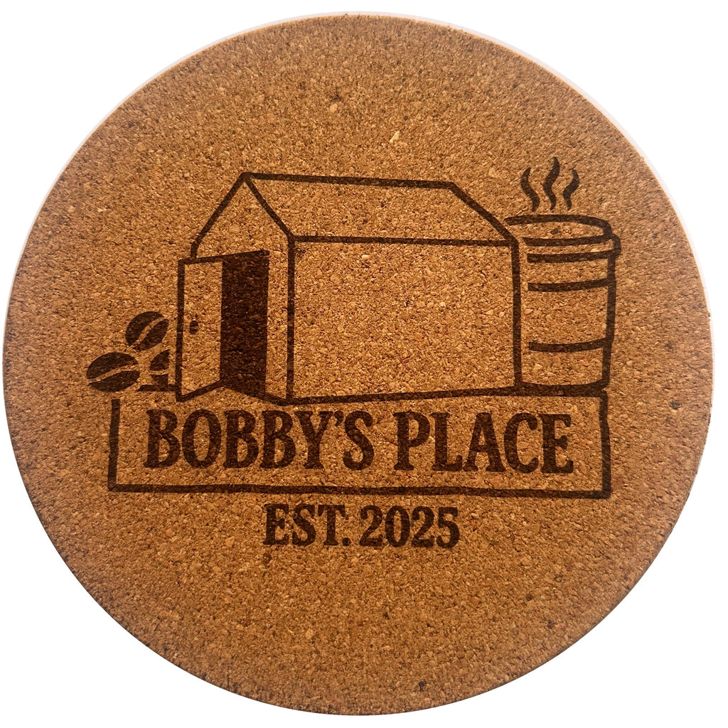 The Giant Coaster — round cork coaster engraved with the Bobby's Place Est. 2025 design
