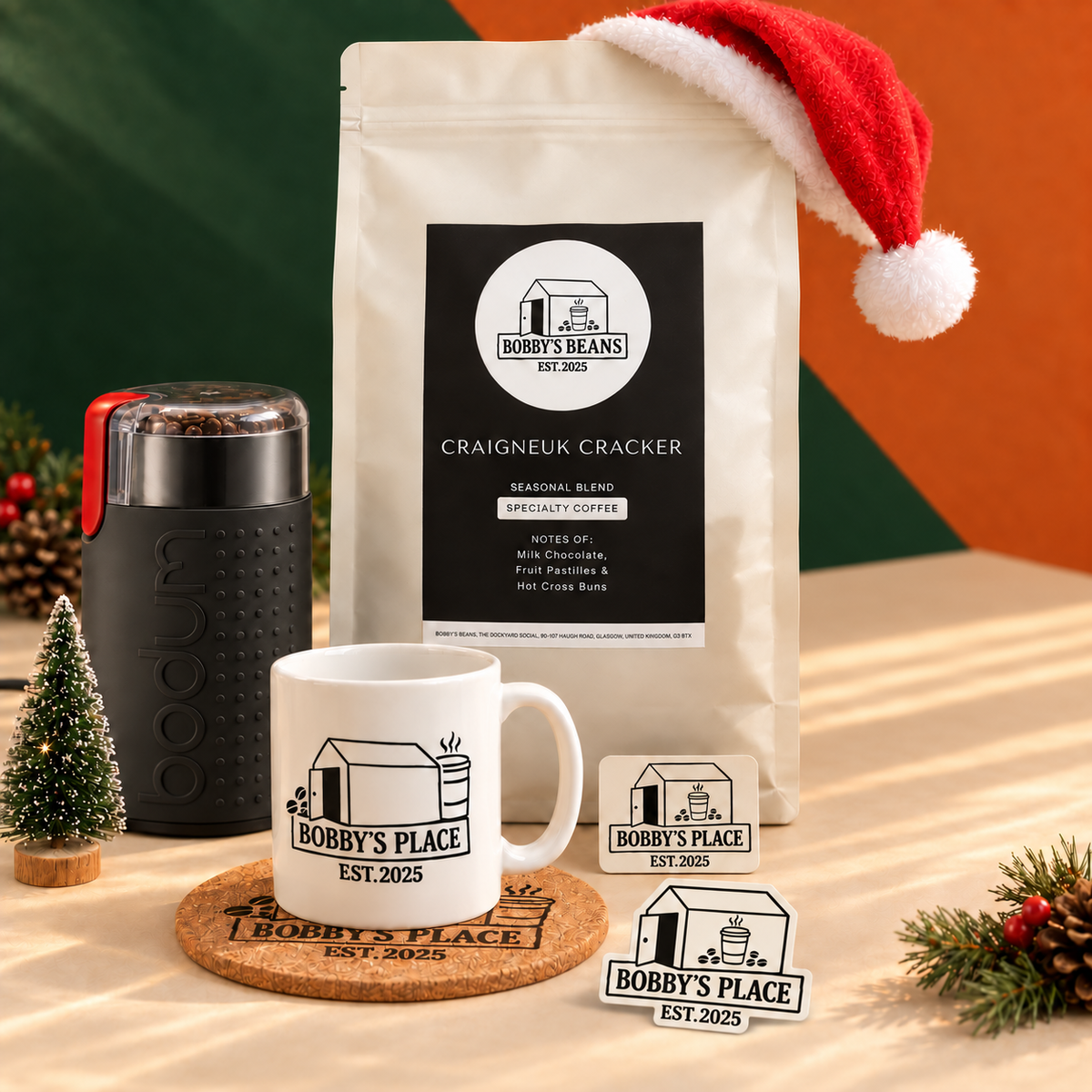 The Christmas Cracker base bundle without a cafetière, with coffee, Bodum grinder, mug, coaster, magnet and Bobby's Place sticker.